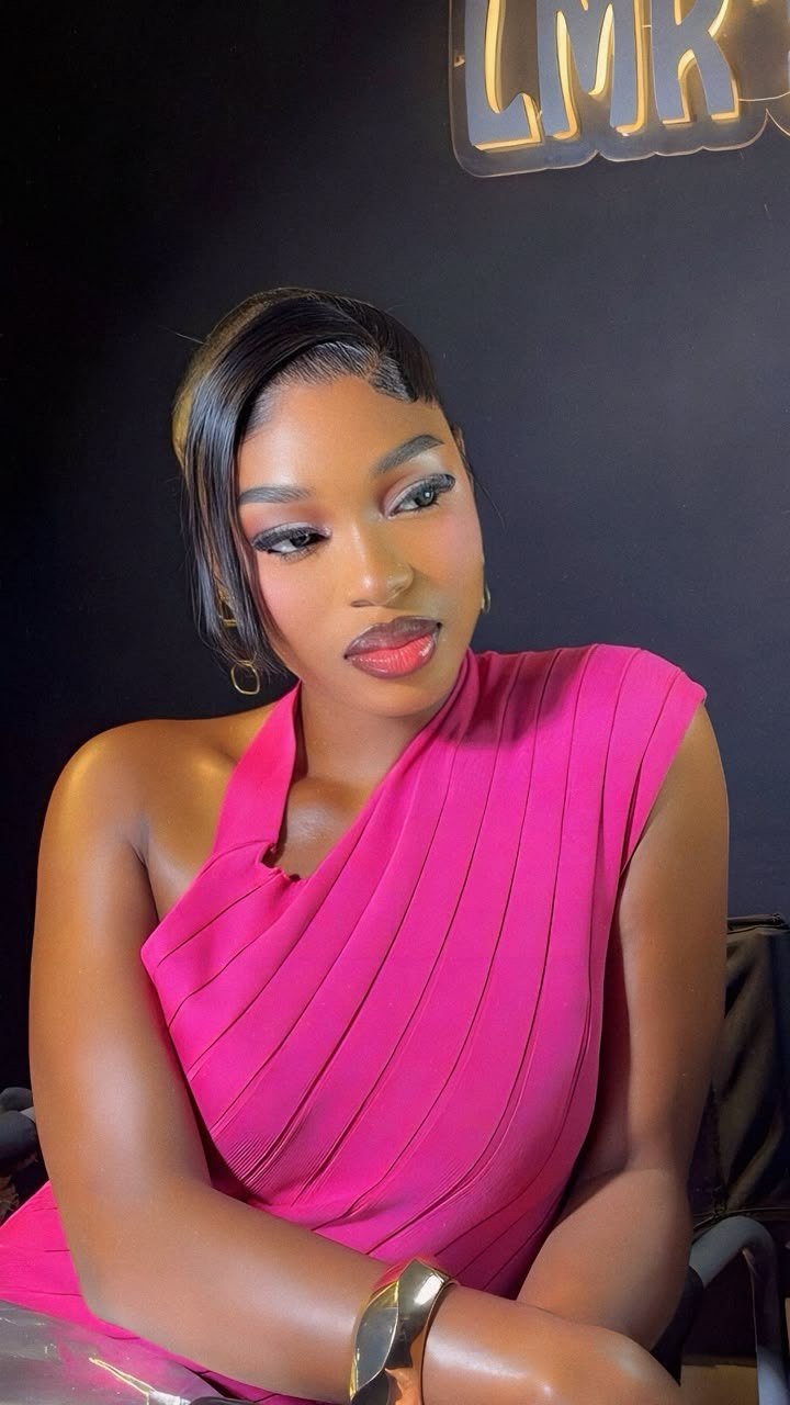 Client in a pink dress wearing polished soft glam makeup